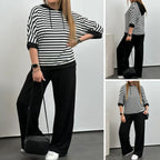 Costum de damă cu top cu dungi și pantaloni de culoare uni