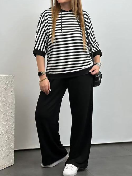Costum de damă cu top cu dungi și pantaloni de culoare uni
